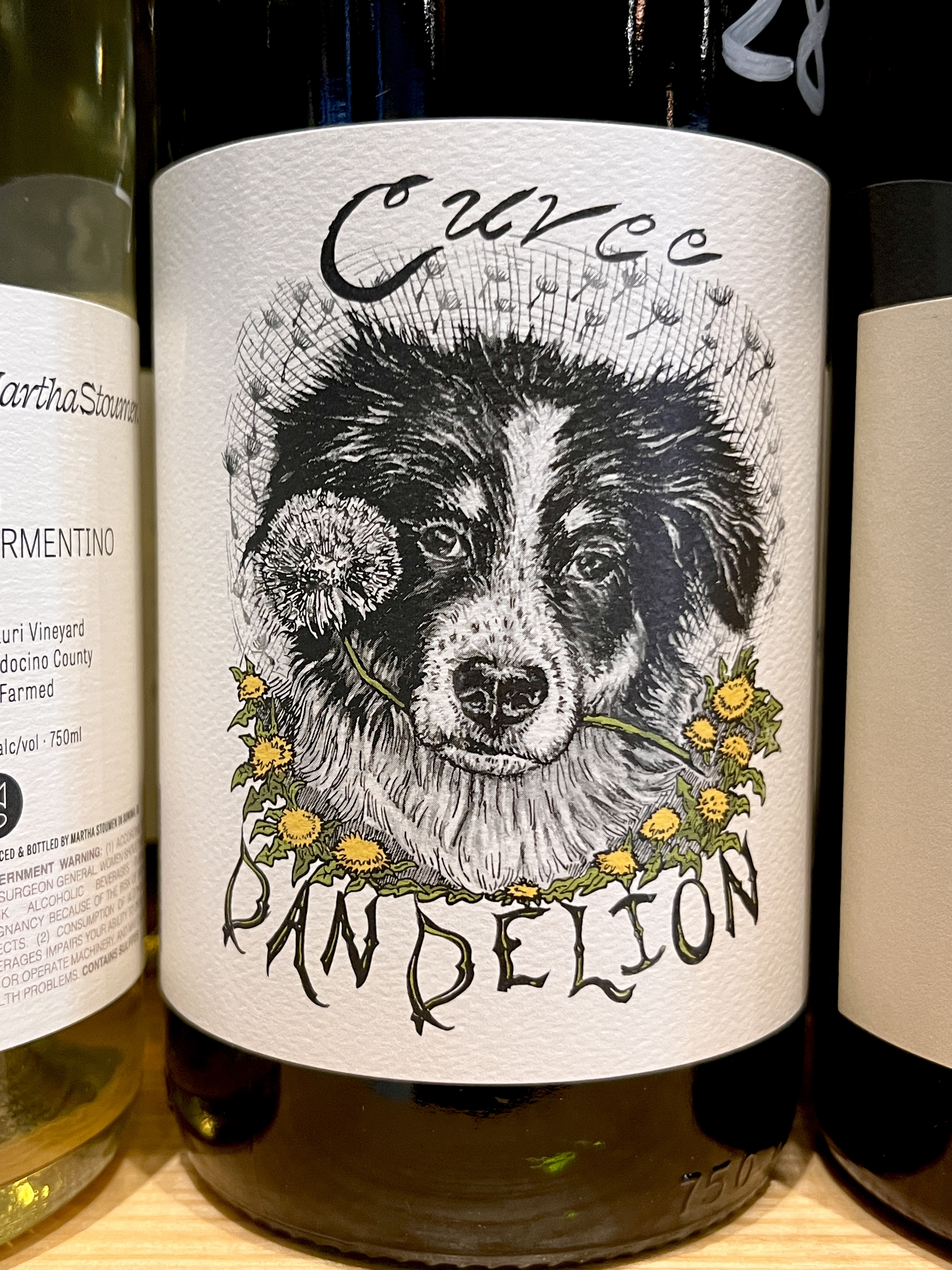 An image of a bottle of wine with a label drawn and designed by Liz Bannish